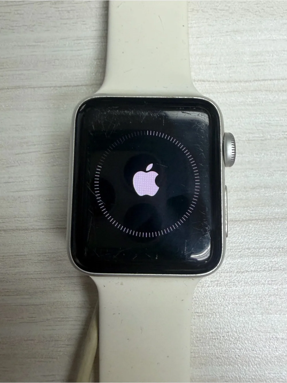 Apple Watch with White Sport Band and Silver Case with charger cable